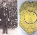 Police Chief Charlie Hamby and the first badge used by the police department